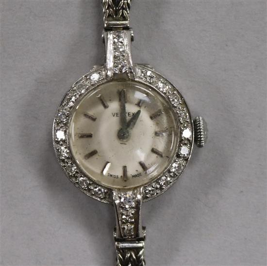 A ladys 1960s 18ct white gold and diamond set Vertex manual wind cocktail watch, on a 9ct white gold double strand bracelet.